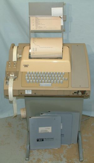 An ASR-33 Teletype machine, complete with paper tape. Image of an ASR-33 Teletype machine